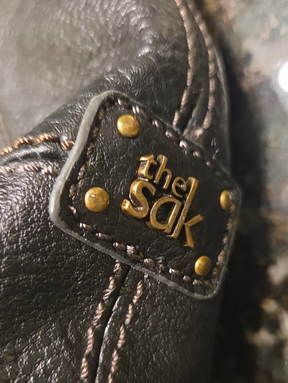 The Sak Black Pebbled Leather Shoulder Bag with Charm Accents